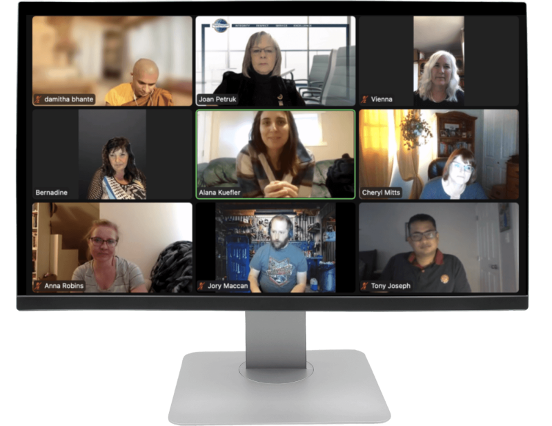 A 3 by 3 view of attendees on a Zoom Toastmasters meeting on a monitor.